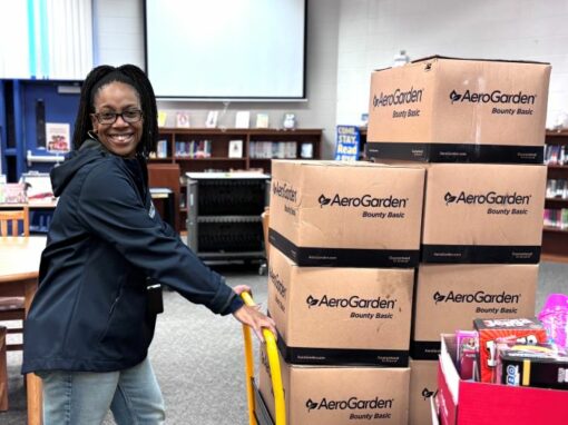 Happy staff with boxes of AeroGardens
