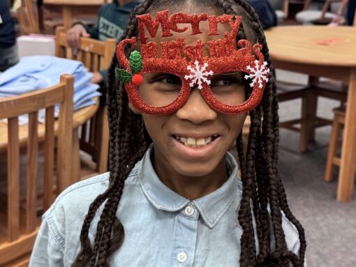 Girl with Merry Christmas glasses