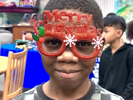 Boy with Merry Christmas glasses
