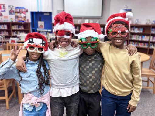 Group of 4 children with Christmas glasses on