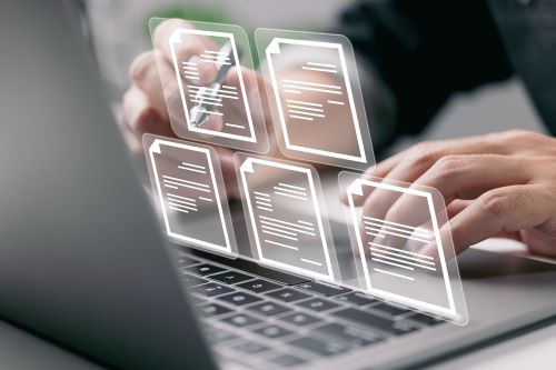 Man on laptop with image of file folder floating beside him