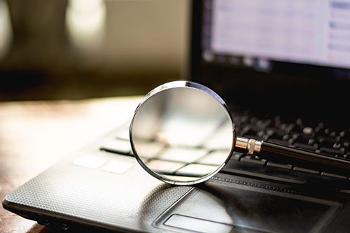 magnifying glass on laptop